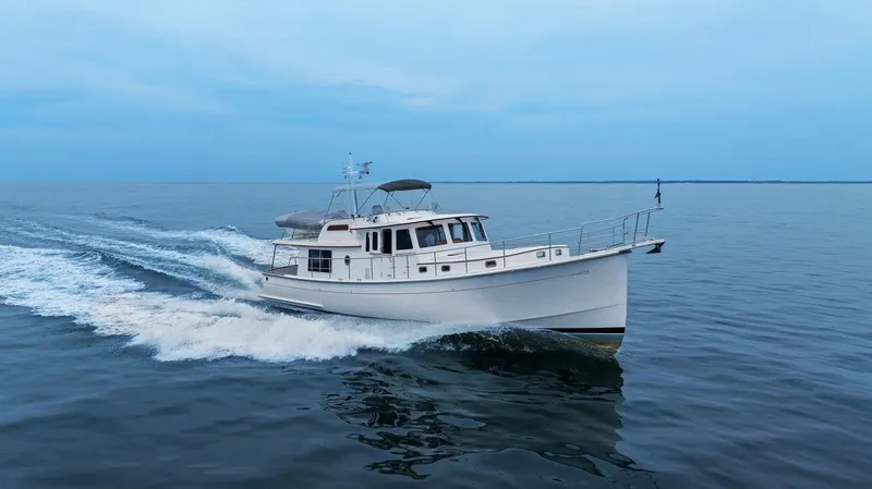 Dogfish Yacht Photos Pics 2023 Krogen Express 52 cruising on calm ocean waters.