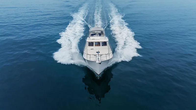Dogfish Yacht Photos Pics 2023 Krogen Express 52 yacht cruising on open water, aerial view.