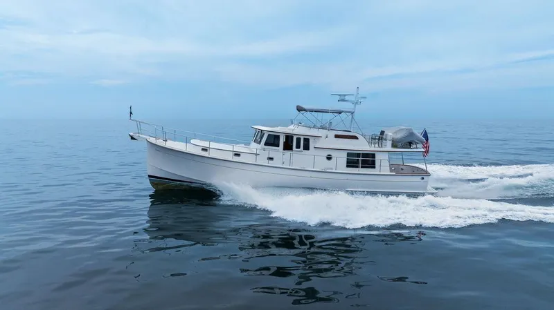 Dogfish Yacht Photos Pics 2023 Krogen Express 52 cruising on calm ocean waters.