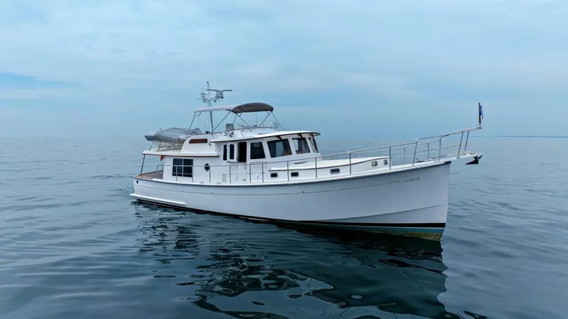 Dogfish Yacht Photos Pics 2023 Krogen Express 52 yacht on calm ocean waters.