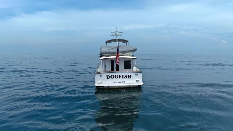 Dogfish Yacht Photos Pics Krogen Express 52 yacht "Dogfish" on calm ocean waters, 2023 model.