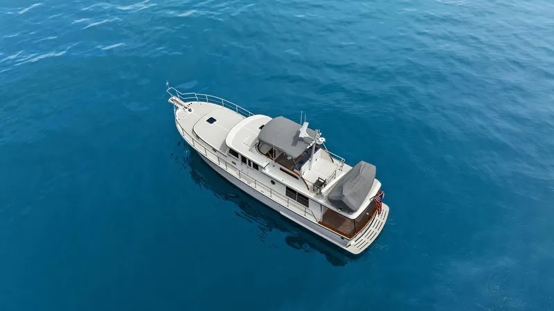 Dogfish Yacht Photos Pics 2023 Krogen Express 52 yacht cruising on clear blue water.