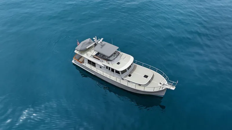 Dogfish Yacht Photos Pics 2023 Krogen Express 52 yacht cruising on calm blue waters.