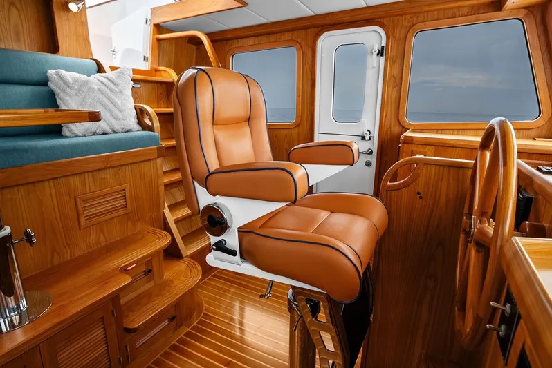 Dogfish Yacht Photos Pics Luxurious interior of 2023 Krogen Express 52 yacht with leather seating and wooden finishes.