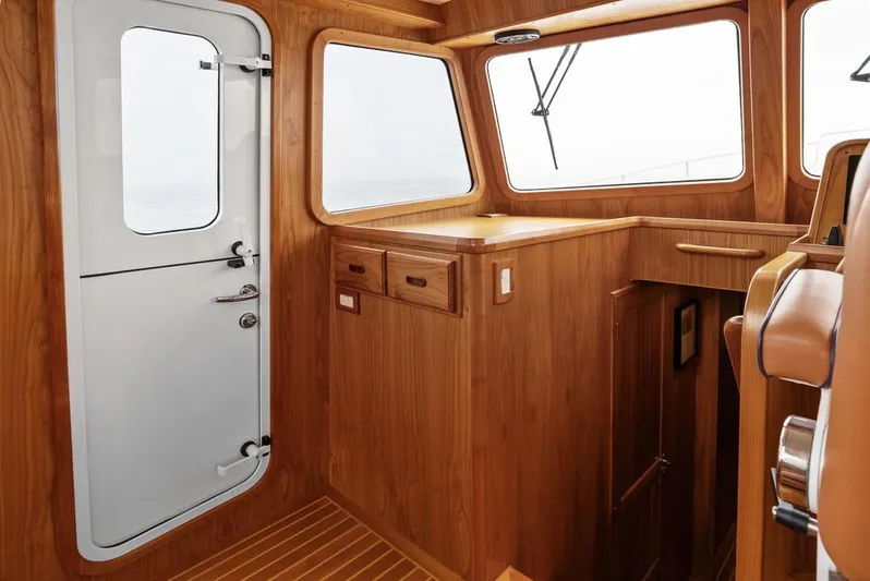 Dogfish Yacht Photos Pics Interior of 2023 Krogen Express 52 yacht with wooden finish and white door.