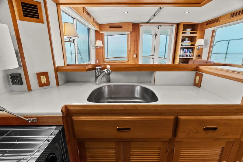 Dogfish Yacht Photos Pics Luxurious 2023 Krogen Express 52 yacht interior with modern kitchen and ocean view.