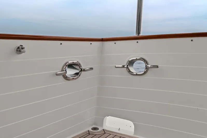 Dogfish Yacht Photos Pics 2023 Krogen Express 52 yacht deck with portholes and wooden trim.