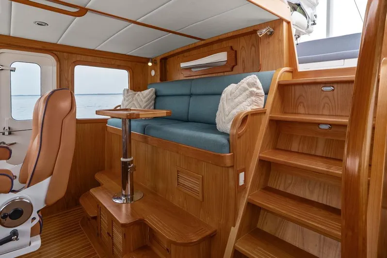 Dogfish Yacht Photos Pics Luxurious interior of 2023 Krogen Express 52 yacht with wooden finish and plush seating.