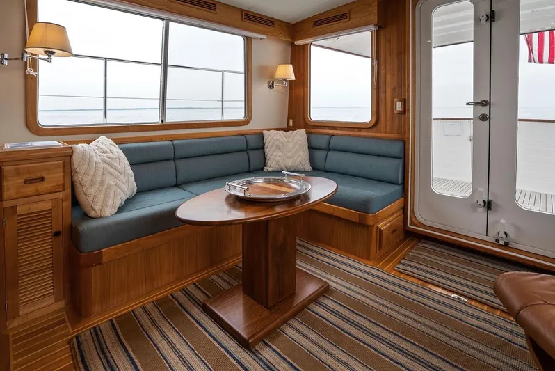 Dogfish Yacht Photos Pics Luxurious 2023 Krogen Express 52 yacht interior with cozy seating and elegant wooden finishes.