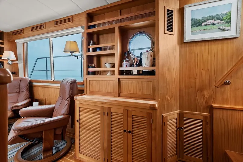 Dogfish Yacht Photos Pics Luxurious interior of 2023 Krogen Express 52 yacht with wooden cabinetry and leather seating.