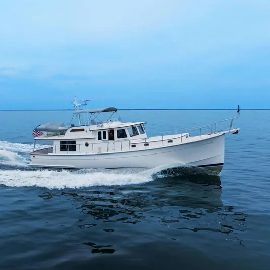 Dogfish Yacht Photos Pics 2023 Krogen Express 52 yacht cruising on calm blue waters.
