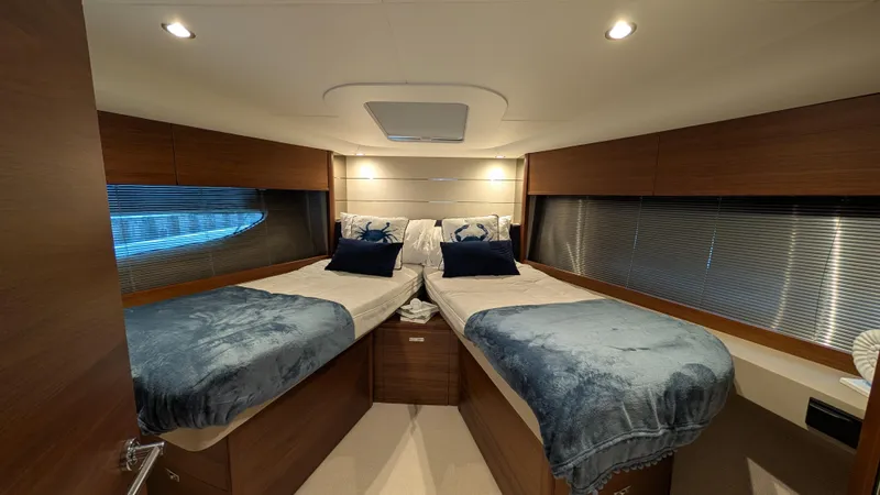  Yacht Photos Pics Luxurious 2021 Princess V50 yacht cabin with twin beds and elegant decor.