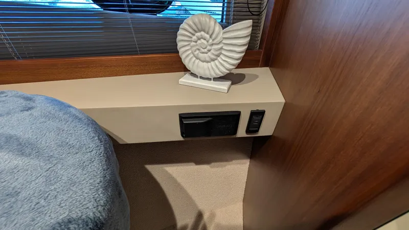  Yacht Photos Pics Interior of 2021 Princess V50 yacht with decorative nautilus shell sculpture.