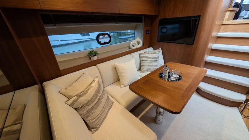  Yacht Photos Pics Luxurious interior of 2021 Princess V50 yacht with elegant seating and wooden accents.