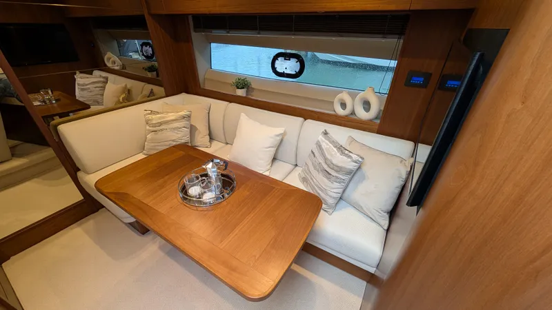  Yacht Photos Pics Luxurious interior of 2021 Princess V50 yacht with elegant seating and wooden table.