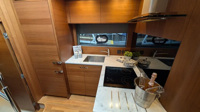  Yacht Photos Pics Luxurious 2021 Princess V50 yacht kitchen with modern appliances and elegant wood cabinetry.