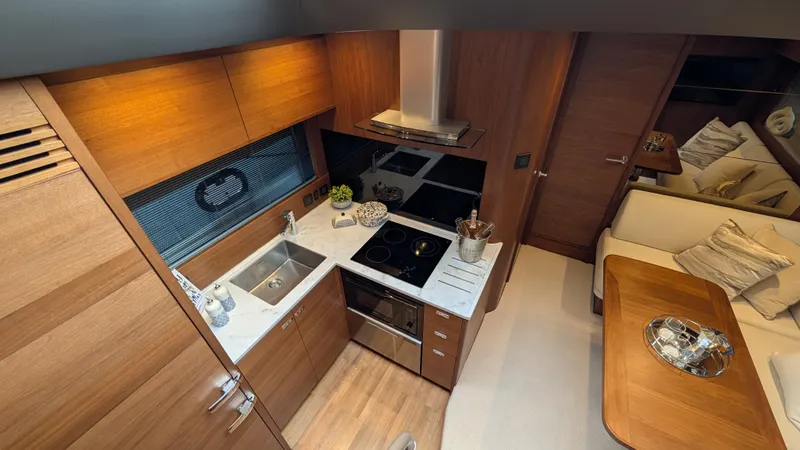 Yacht Photos Pics Luxurious 2021 Princess V50 yacht interior with modern kitchen and cozy seating area.