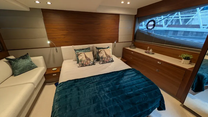  Yacht Photos Pics Luxurious bedroom interior of 2021 Princess V50 yacht with elegant decor and modern furnishings.