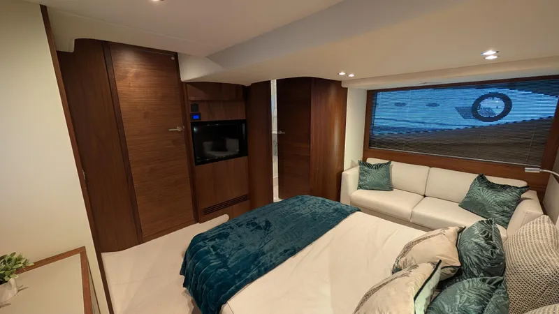  Yacht Photos Pics Luxurious interior of 2021 Princess V50 yacht with elegant wood finishes and plush seating.