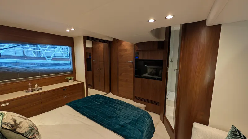  Yacht Photos Pics Luxurious interior of a 2021 Princess V50 yacht cabin with modern wood finishes.