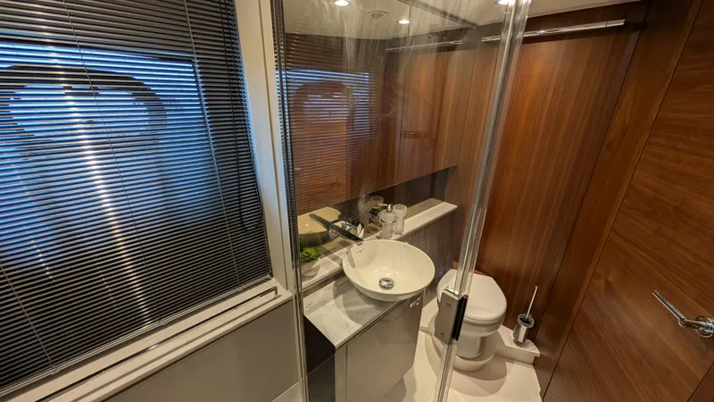  Yacht Photos Pics Luxurious bathroom in 2021 Princess V50 yacht with modern fixtures and wooden accents.