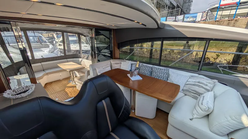  Yacht Photos Pics Luxurious interior of a 2021 Princess V50 yacht with elegant seating and dining area.