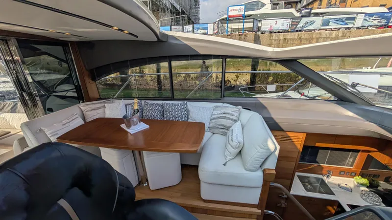  Yacht Photos Pics Luxurious interior of a 2021 Princess V50 yacht with elegant seating and table.