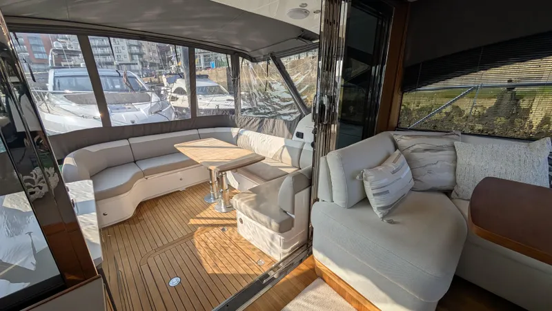  Yacht Photos Pics Luxurious 2021 Princess V50 yacht interior with elegant seating and wooden flooring.