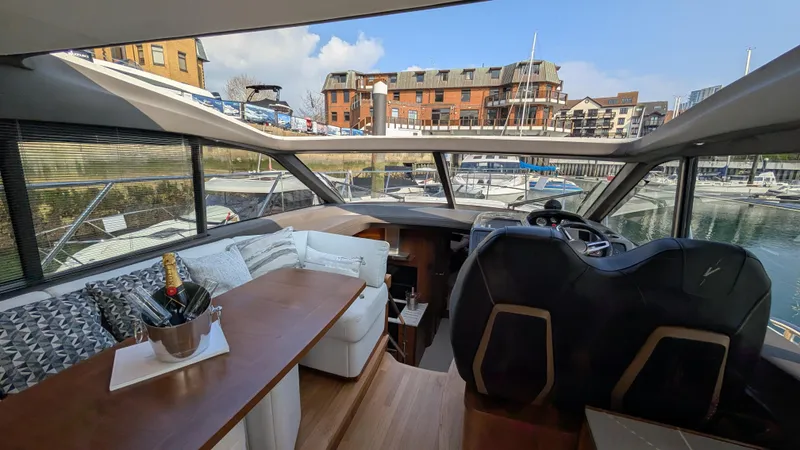  Yacht Photos Pics Interior of 2021 Princess V50 yacht with luxurious seating and marina view.