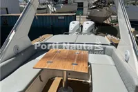 2020 Capelli Tempest 40 boat interior with seating and wooden table.