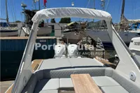 2020 Capelli Tempest 40 boat with cushioned seating and twin engines in a marina.