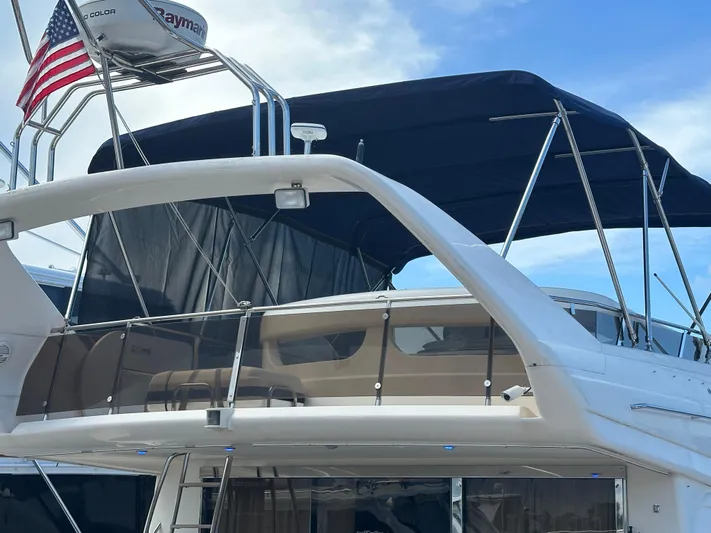  Yacht Photos Pics 2000 Viking Princess Sport Cruiser with American flag and Raymarine equipment, docked under blue sky.