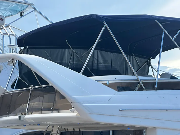  Yacht Photos Pics Viking Princess Sport Cruiser 2000 with blue canopy and sleek design.