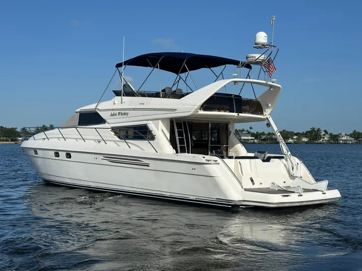  Yacht Photos Pics 2000 Viking Princess Sport Cruiser yacht on calm water, featuring sleek design and spacious deck.