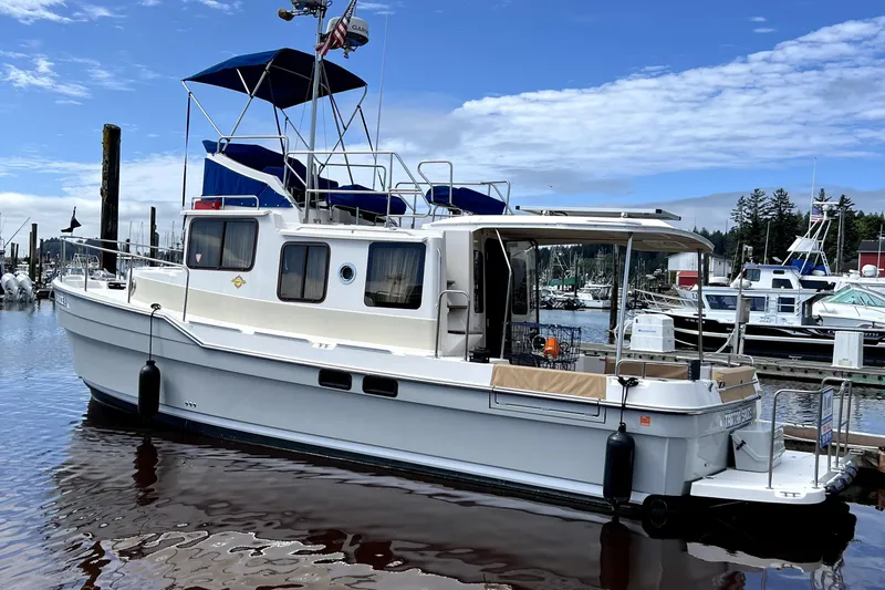  Yacht Photos Pics 2021 Ranger Tugs R-31 CB boat docked at a marina under a blue sky.