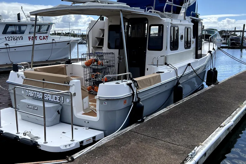  Yacht Photos Pics 2021 Ranger Tugs R-31 CB docked, featuring crab pots and open deck area.