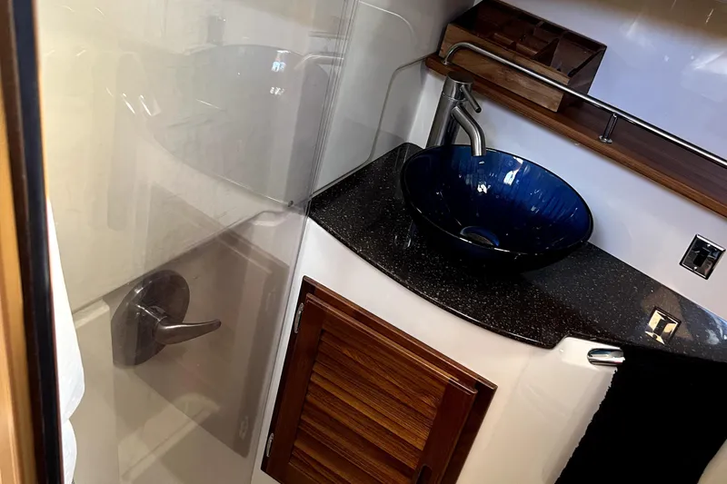  Yacht Photos Pics Luxurious bathroom in 2021 Ranger Tugs R-31 CB with modern blue vessel sink.