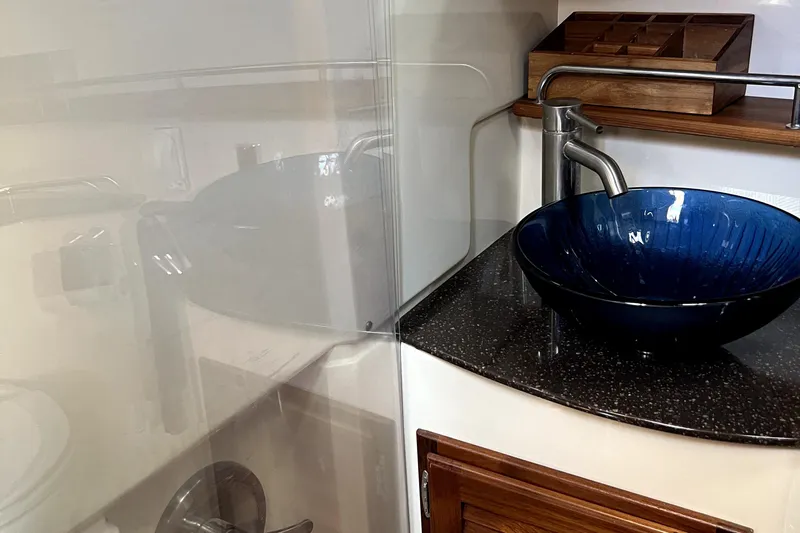  Yacht Photos Pics Elegant bathroom sink with blue vessel in 2021 Ranger Tugs R-31 CB boat.