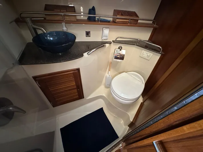  Yacht Photos Pics Bathroom interior of 2021 Ranger Tugs R-31 CB with modern fixtures and wooden accents.