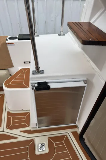  Yacht Photos Pics 2021 Ranger Tugs R-31 CB boat interior with stainless steel door and wooden accents.