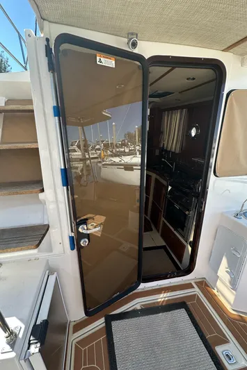  Yacht Photos Pics 2021 Ranger Tugs R-31 CB boat interior with open glass door and visible kitchen area.