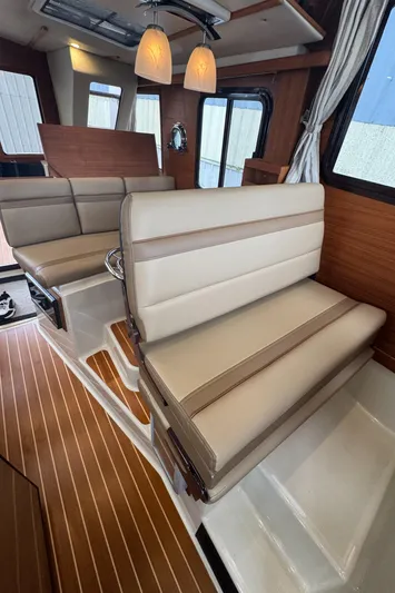  Yacht Photos Pics Interior of 2021 Ranger Tugs R-31 CB with beige seating and wood accents.