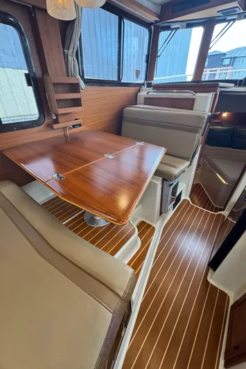  Yacht Photos Pics 2021 Ranger Tugs R-31 CB interior with wood flooring and dining area.