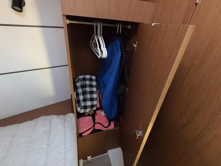  Yacht Photos Pics Closet interior on 2021 Beneteau Oceanis 38.1 yacht with clothes and hangers.