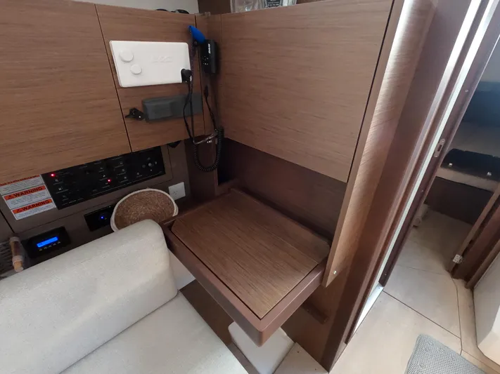  Yacht Photos Pics Interior of 2021 Beneteau Oceanis 38.1 yacht with wooden desk and seating area.