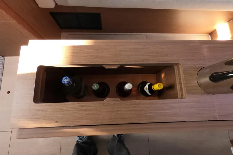  Yacht Photos Pics Built-in wine storage on 2021 Beneteau Oceanis 38.1 yacht interior.