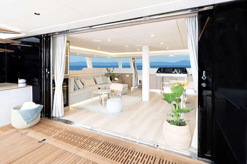 Betame Yacht Photos Pics Luxurious interior of 2021 Sunreef 60 yacht with elegant decor and ocean view.