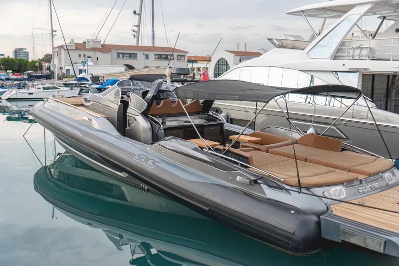 Aquaholic Yacht Photos Pics 2017 Sacs Marine Strider 18 luxury yacht docked in marina, featuring sleek design and spacious deck.