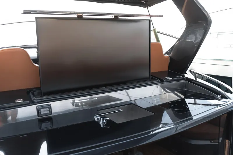 Aquaholic Yacht Photos Pics Luxury yacht Sacs Strider 18, 2017 model, featuring a sleek entertainment area with a retractable TV.