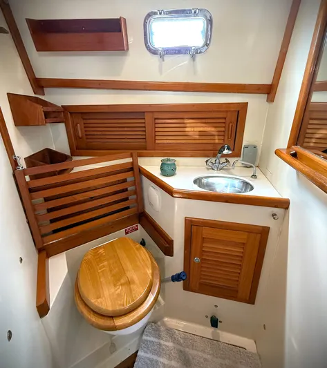 Aria Yacht Photos Pics 2000 Pacific Seacraft 37 yacht bathroom with wooden accents and compact sink.